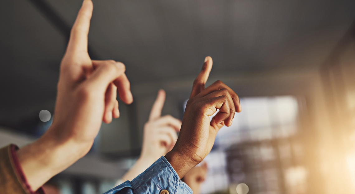 Hands raised at meeting