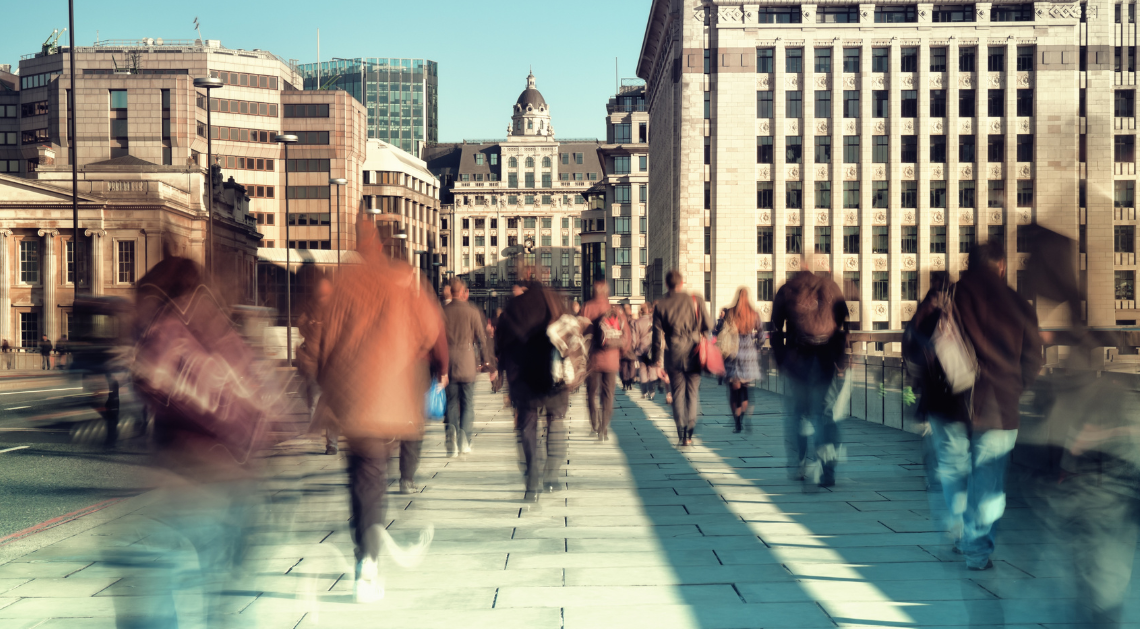 Crowd walking on a bridge with blurred faces